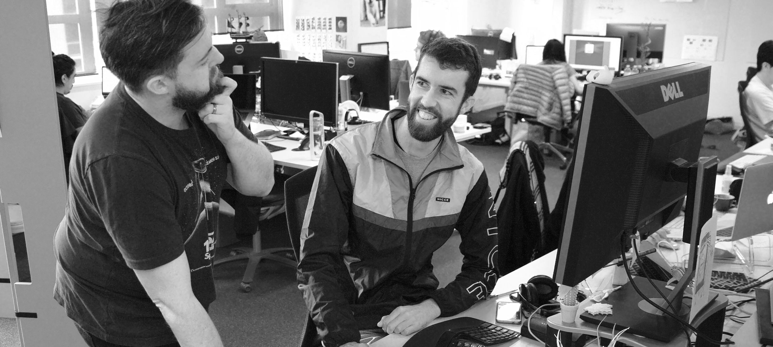 Nate talking to a colleague in the Alphero office